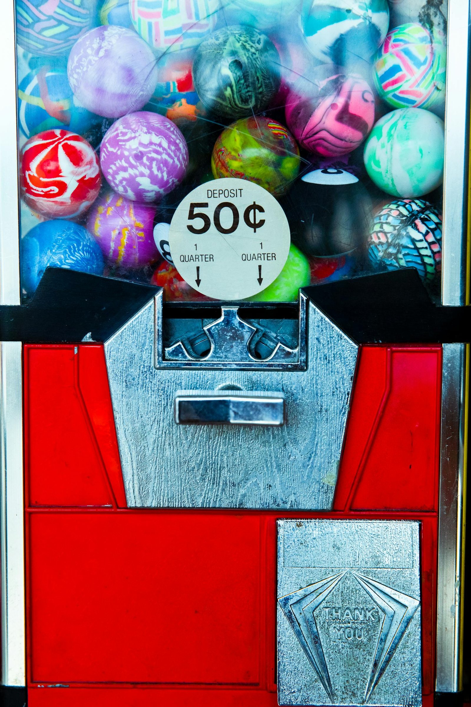 Detailed view of a colorful vintage gumball machine, perfect for retro themes.